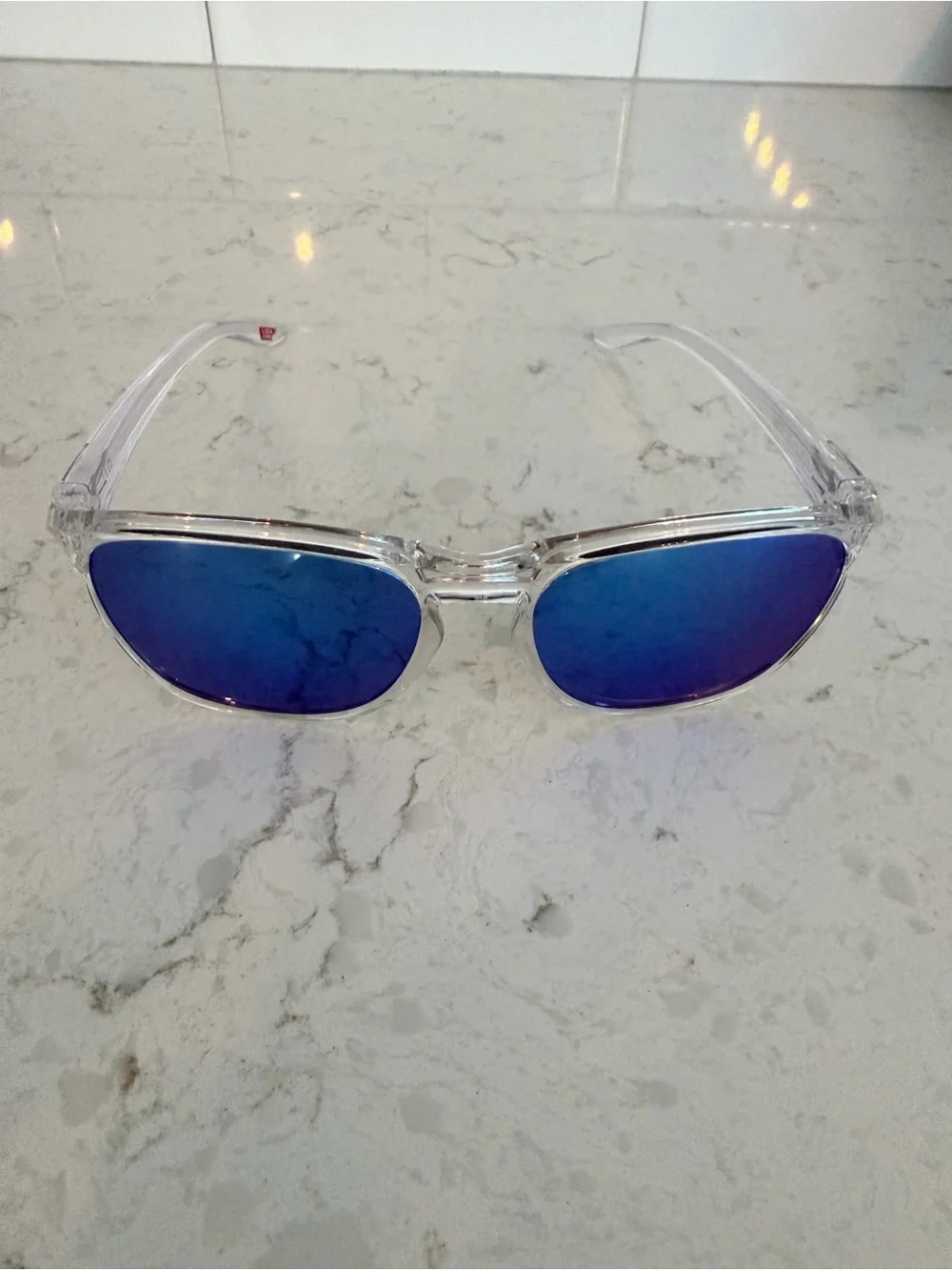 Oakley Clear Frame Sunglasses with Blue Mirrored Lenses